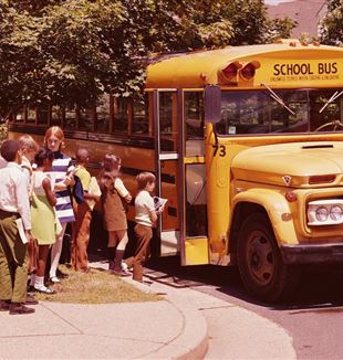 Kids boarding school bus (vintage photograph via Unsplash)